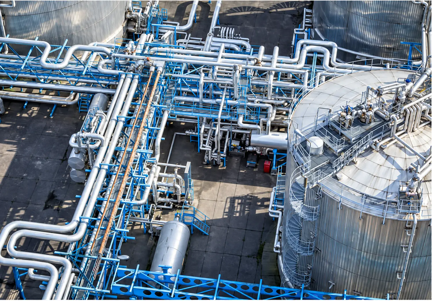 Industrial tanks, structural steel and integrated pipework at a project site